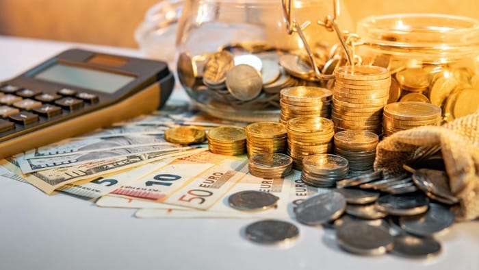 Monety i banknoty na stole symbolizujące kryzys finansowy
